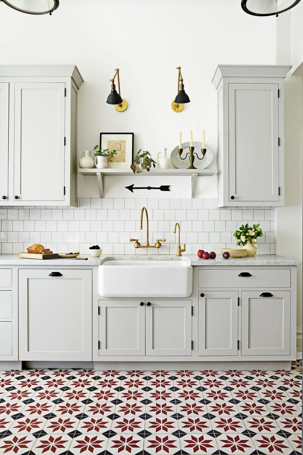 All white kitchen with red and black Scandinavian style floor tile
