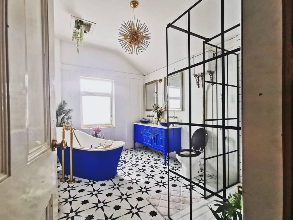 Blue and white themed bathroom with funky black and white floor tiles
