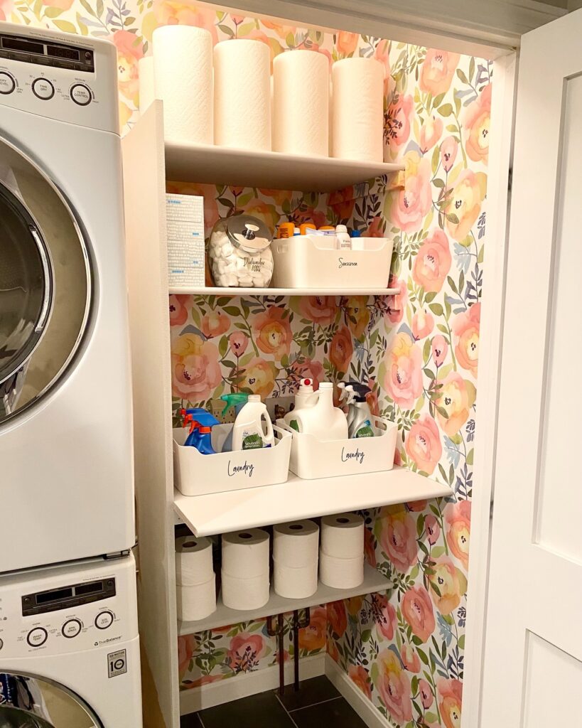 Get organized this weekend! Pink floral peel and stick wallpaper transforms this laundry room closet space with ease!